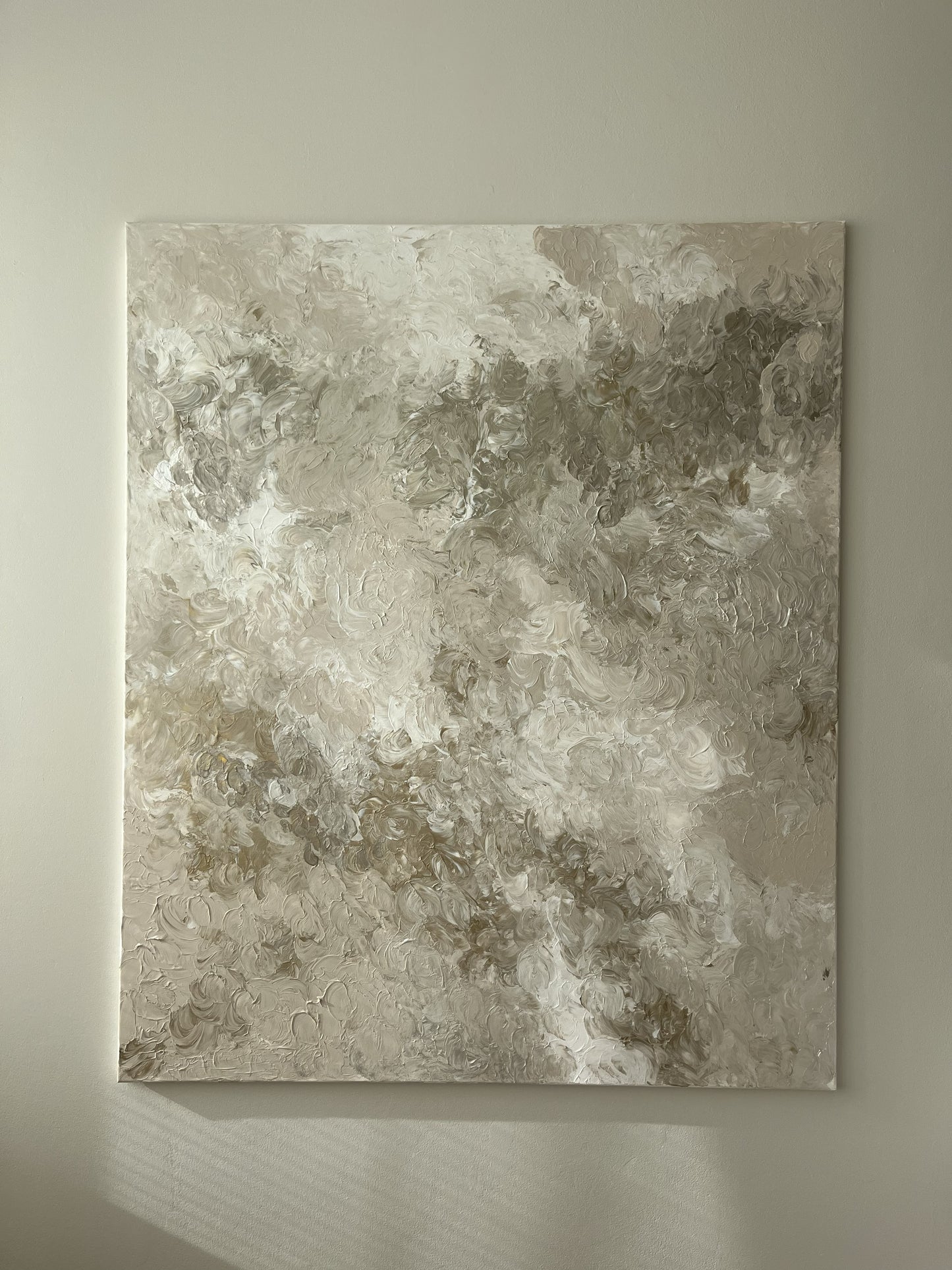 Abstract art piece on a beige wall