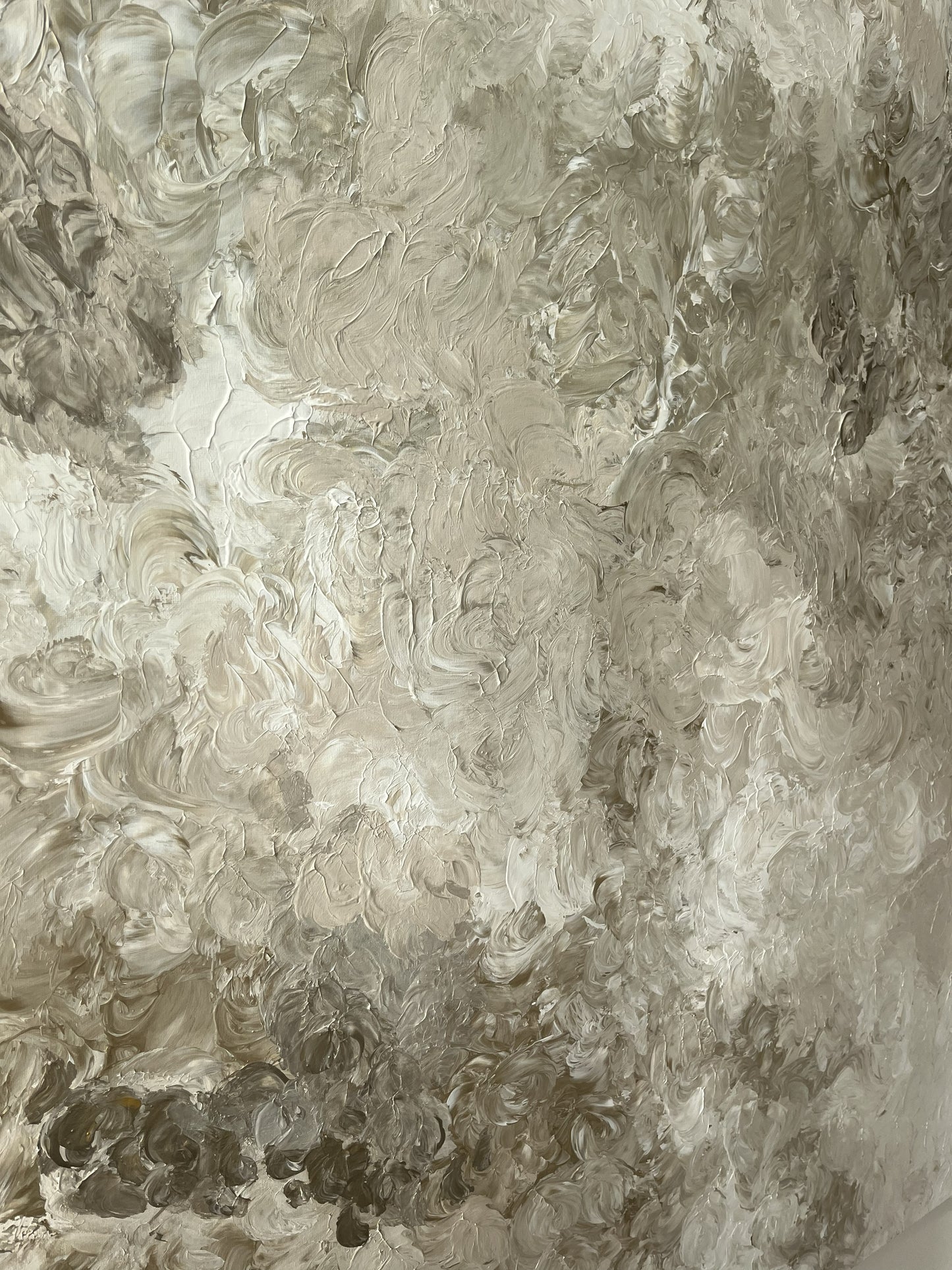 Close-up of a textured wall with swirling patterns in neutral tones.